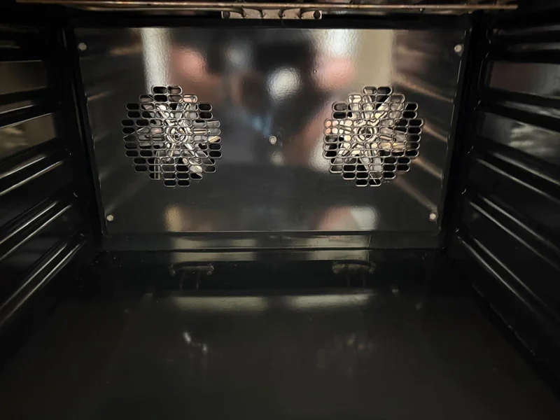 Oven interior after cleaning, with its two fans visible